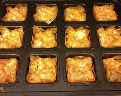 Buffalo Chicken Cups
Ingredients:

1 (8 ounce) package cream cheese, softened
1/2 cup Ranch dressing
1/2 cup Buffalo wing sauce
1 cup shredded cheddar cheese
1 1/2 cups cooked and shredded chicken
24 wonton wrappers
1/4 cup blue cheese crumbles (optional)

Directions:
Preheat oven to 375 degrees. Spray brownie pan very lightly with cooking spray.
In a medium bowl, combine softened cream cheese, Ranch dressing, wing sauce and 3/4 Cup cheddar cheese (save remaining 1/4 cup for topping). You can soften the mixture slightly in the microwave if needed to make it come together. Stir in shredded chicken.   Start layering your cups. Begin with a wonton wrapper and press it into the bottom of each muffin tin. Spoon about a tablespoon of the chicken mixture. Top with another wonton wrapper and add another tablespoon of chicken mixture. Sprinkle with remaining cheddar cheese and a little blue cheese, if desired.
Bake for 18 minutes or until edges are brown. Check cups after 10 minutes into cooking and if edges are browned cover the cupcakes with foil for the remaining cooking time.  Remove from oven and let cool for 5 minutes. Use a knife if needed to loosen the edges then pop each cup out.