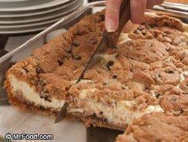 CHOCOLATE CHIP CHEESECAKE:
Serves: 15 Cooking Time: 45 min
What You'll Need:
3 (8-ounce) packages cream cheese, softened
3 eggs
3/4 cup sugar
1 teaspoon vanilla extract
2 (16.5-ounce) rolls refrigerator chocolate chip cookie dough

What To Do:
1) Preheat oven to 350 degrees F.
2) In a large bowl, beat together cream cheese, eggs, sugar, and vanilla extract until well mixed; set aside.
3) Slice cookie dough rolls into 1/4-inch slices. Arrange slices from one roll on bottom of a greased 9- x 13-inch baking dish; press together so there are no holes in dough. Spoon cream cheese mixture evenly over dough; top with remaining slices of cookie dough.
4) Bake 45 to 50 minutes, or until golden and center is slightly firm.
5) Remove from oven, let cool, then refrigerate. Cut into slices when well chilled.

TIP: Keep cookie dough refrigerated until just before slicing. You can serve the cheesecake plain, with chocolate sauce, with fudge or whipped topping...whatever's your favorite.