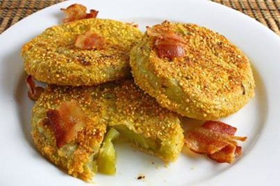 Cherokee Fried Green Tomatoes

Ingredients: 
2 lbs. Green tomatoes 
4 eggs 
1 1/4 cup Corn meal 
3/4 cup Water 
1/4 cup Minced chives or wild onions 
1 Tbsp. Salt 
1/4 tsp. Pepper, fresh ground 
1/4 cup Butter or margarine 
Directions 
Slice the tomatoes 1/2" thick, but do not peel or core. Drain well between several 
thicknesses of paper toweling until most of the moisture of the tomatoes is absorbed. 
While the tomatoes are draining, make a batter by beating the eggs until light, then 
mixing in the corn meal, water, minced chives, salt, and pepper. In a large, heavy iron 
skillet, heat the butter or margarine until bubbly. Dip the tomato slices into the batter, and 
brown quickly on both sides. Serve immediately, but phone me first so I can come over.