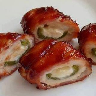 Chicken Bombs aka Jalapenos stuffed with cream cheese and colby Jack, wrapped with chicken breast and bacon and basted with BBQ sauce ~Frisky

 Repost 

Ingredients
5 boneless, skinless chicken breasts-makes 10 bombs
5 jalapenos, sliced in half lengthwise and cleaned
20 slices bacon
4 oz cream cheese, softened
1C colby jack or cheddar cheese, shredded
S&P to taste
1 C BBQ sauce-

Directions
Slice chicken breasts in half (like a hamburger bun), place between wax paper and pound until it’s 1/4” thick. Season with S&P. Mix the two cheeses together and smear about 1 Tblsp into each pepper half (just use up the cheese between all of the peppers). Place the pepper on the chicken breast and wrap it up as best you can. I suggest placing the pepper cheese side down so it gets completely covered by the chicken. 
Wrap each chicken breast completely with two pieces of bacon. Start at one end, wrap half the breast and finish the second half with the other piece of bacon. 
Cook on a preheated 350 degree grill over indirect heat for 30 minutes or until chicken is done. Turn every 5 minutes and baste with BBQ sauce each time you turn it. 
For oven: Bake at 375 degrees for 30 minutes or until chicken is done. Baste a couple times and finish under the broiler to set the BBQ sauce. **I suggest a 400 degree oven and no BBQ sauce for the first 20 minutes, turning once to help cook the bacon. Then reduce heat to 375, change pans to loose some of the bacon fat (if you don’t have a broiler pan), cover in BBQ sauce and finish baking