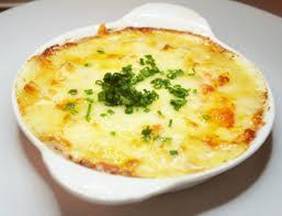 Crab Meat Au'Gratin by Katherine Ross

1 lb. lump crabmeat
1 stick of butter
Small onion, chopped finely
1 stalk of celery, chopped finely
1/2 cup flour
2 egg yolks
1 (12 oz) can of evaporated milk 
Beazell’s Cajun Seasoning to taste

Saute’ onion and celery in butter until wilted. Take off heat and stir in flour, egg yolks, evaporated milk and Beazell’s Cajun Seasoning slowly. Put back on the heat and stir continuously until thickened into almost a ball and the butter starts oozing. Take off the heat, stir in the crabmeat. Put mixture into a casserole dish, sprinkle with shredded cheddar. Bake at 375 degrees for 15-20 minutes until cheese is bubbly!