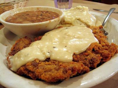Del Rancho Chicken Fried Steak

4 (1/2 pound) beef cube steaks
2 cups all-purpose flour
2 teaspoons baking powder
1 teaspoon baking soda
1 teaspoon black pepper
3/4 teaspoon salt
1½ cups buttermilk
1 egg
1 Tablespoon hot pepper sauce (e.g., Tabasco™)
2 cloves garlic, minced
3 cups vegetable shortening for deep frying
1/4 cup all-purpose flour
4 cups milk
kosher salt and ground black pepper to taste

1. Pound steaks to about 1/4-inch thickness. Place 2 cups of flour in a shallow bowl. Stir together the baking powder, baking soda, pepper, and salt in a separate shallow bowl; stir in the buttermilk, egg, Tabasco Sauce, and garlic. Dredge each steak first in the flour, then in the batter, and again in the flour. Pat the flour onto the surface of each steak so they are completely coated with dry flour.
2. Heat shortening in a deep cast-iron skillet to 325 degrees F (165 degrees C). Fry the steaks until evenly golden brown, 3 to 5 minutes per side. Place fried steaks on a plate with paper towels to drain. Drain the fat from the skillet, reserving 1/4 cup of the liquid and as much of the solid remnants as possible
3. Return skillet to medium-low heat with the reserved oil. Whisk the remaining flour into the oil. Scrape the bottom of the pan with a spatula to release solids into the gravy. Stir in the milk, raise the heat to medium, and bring the gravy to a simmer, cook until thick, 6 to 7 minutes. Season with kosher salt and pepper. Spoon the gravy over the steaks to serve.