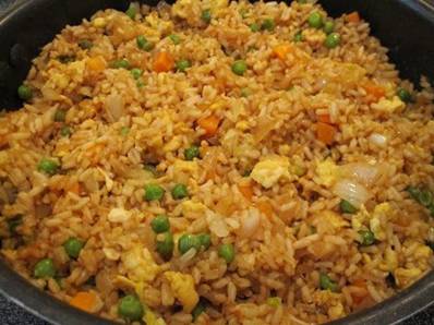 Fried Rice

3 cups cooked white rice (day old or leftover rice works best!)
3 tbs sesame oil
1 cup frozen peas and carrots (thawed)
1 small onion, chopped
2 tsp minced garlic
2 eggs, slightly beaten
1/4 cup soy sauce


On medium high heat, heat the oil in a large skillet or wok. Add the peas/carrots mix, onion and garlic. Stir fry until tender. Lower the heat to medium low and push the mixture off to one side, then pour your eggs on the other side of skillet and stir fry until scrambled. Now add the rice and soy sauce and blend all together well. Stir fry until thoroughly heated! **You could really play around with this rice too! Try adding some diced ham, or green onion :) Yum!