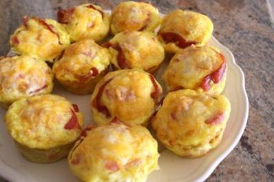 Ham and Cheese Biscuit Cups

1 tube refrigerator biscuits 
1/2 cup cheddar or swiss cheese, whatever you like
1/2 cup ham cut in small pieces 
2-3 eggs
Salt and pepper
Cooking spray/butter/oil
Muffin tin

Grease your muffin tin and preheat oven to 375 degrees.
Press the biscuits flat with your hands and press then them into the muffin tin cups. Fill the biscuit cups with the ham and cheese.
Whip eggs in a separate bowl and fill the cups evenly with the egg mixture. Season with salt and pepper. Bake the cups for 20-25 minutes, until the eggs have set and the biscuits are golden brown.