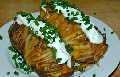 ☆.•♥•Hasselback Garlic Potatoes w/ Bacon & Cheese Recipe!•♥•☆


For many people, Hasselback style potatoes are nothing new.  
Make some slices in a potato, bake, and it magically fans out into an impressive looking potato with LOTS of character indeed, making for a brilliant addition to any meal!
 
Ingredients
16 ounces potatoes
3 to 5 garlic cloves, thinly sliced
4 tablespoons butter, melted
2 tablespoons olive oil
salt and fresh black pepper
Fresh chives (diced)
Bacon (cut into large chunks)
Shredded Cheese of your choice- 1-cup
Sour Cream, recipe follows**

Directions
Preheat oven to 400 degrees F.

Using a wooden spoon as a cradle, place each potato in the spoon and make several parallel slits into each potato top making sure not to slice completely through. 

Place 3 garlic slices between slits at the crown of each potato. Toss in a medium bowl with butter and olive oil. 

Place on a baking sheet lined with tin foil and sprinkle generously with salt and pepper.

When the potatoes begin to “fan out” it’s time to make the magic happen.Carefully slip a hunk of bacon into each slit of the potato like so and continue to cook

 Once the potatoes and bacon are fully cooked (use a knife poke test), coat the potatoes with heaping helping of shredded cheese. .

 Bake until tops are crispy and potatoes are cooked through, about 1 hour. Transfer to a platter and top with Herbed Sour Cream and chives.

Herbed Sour Cream:
1/2 cup sour cream
1/2 teaspoon garlic powder
1 tablespoon finely chopped fresh parsley leaves
Kosher salt and freshly ground black pepper
Combine ingredients in a small bowl. Season, to taste, and refrigerate until use.