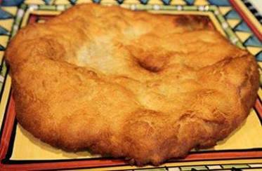 WooHoo I found it! I've been looking for this recipe for several years! 
 Indian Frybread

 Ingredients:
 
 4 cups of flour
 1 tbs. baking powder
 1 teaspoon salt
 2 tbs. powdered milk
 1 ½ cups warm water
 1 cup shortening
 Extra flour to flour your hands

 Directions:

 Put flour in bowl, add baking powder, salt and powdered milk. Mix.

 Mix in warm water to form dough.

 Cover hands in flour.

 Knead dough by hand until soft but not sticky. Cover with a cloth and let stand for 15 minutes.

 Shape dough into balls about 2 inches across then flatten by patting and stretching the dough.

 Melt shortening about an inch deep in frying pan. When hot put dough in pan. Fry one side till golden brown, then turn and fry the other.

 This is a wonderful bread that can be used as a dessert by topping with honey, powdered sugar, etc. or can be used for main dishes such as topping with taco ingredients for an "Indian Taco".
~~ SHARE IT to SAVE IT ~~   FOLLOW ME or send me a FRIEND REQUEST! Join this group for help on your journey to weight loss, recipes, health tip, friendship, DIY projects and a few laughs! www.facebook.com/groups/YouAreLosingIt   Order here www.skinnycyndde.eatlessfeelfull.com  See this page for handmade leather items www.facebook.com/LeatherLegendsCiji