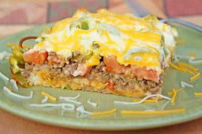 'John Wayne Casserole'
Source: Adapted from Mississippi Magazine


Ingredients


2 pounds ground beef, cooked and drained
1 (1.25-ounce) packet taco seasoning
4 ounces sour cream
4 ounces mayonnaise
8 ounces Cheddar cheese, shredded and divided
1 yellow onion, sliced
2 cups biscuit mix
2 tomatoes, sliced
1 green bell pepper, sliced
1 (4-ounce) can sliced jalapeno peppers


Directions


1. Heat oven to 325. Brown ground beef and add taco seasoning and water, according to packet instructions; set aside.


2. In a separate bowl, combine sour cream, mayonnaise, 4 ounces of cheddar cheese, and half of the onions; set aside.


3. Stir biscuit mix and water (directions on box) to form soft dough. Pat dough on the bottom and one-half-inch up the sides of an 9 x 13 in. greased casserole dish.


4. Saute remaining onions and bell peppers until slightly tender.


5. On top of biscuit mix, evenly distribute ingredients in the following order: ground beef, tomato slices, green peppers, onions, jalapeno peppers, sour cream mixture and end with remaining shredded cheese.


6. Bake for 30-40 minutes or until edges of dough are lightly browned.

navywifecook.com