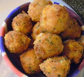 Loaded Potato Bites~YUM
Makes 18-24 bites depending on size


2 cups leftover mashed potatoes
2 tablespoons of flour
2/3 cup of shredded cheddar cheese
3 strips bacon
1/3 cup scallions, chopped
1 egg
1 ¼ - 1 ½ cups Italian bread crumbs
Oil for frying
Salt and Pepper
Ranch or Honey Mustard for dipping


Take potatoes out of the fridge and let sit for a few minutes to take the chill off a bit. Meanwhile, shred the cheese, chop scallions, and cook bacon then dice finely. Add potatoes and flour to a large mixing bowl and stir to combine well, then add cheese, bacon, and scallions. Take about a heaping tablespoon of mixture and roll with hands into a small balls. It if doesn’t hold its shape, add a little more flour to make the potatoes sturdy. Heat oil in a medium sauce pan (or use your fryer) over med/med hi heat to about 350-375 degrees. Whisk egg into a small bowl and season with salt and pepper. Place bread crumbs in an additional bowl. Dip each ball in egg and then roll in bread crumbs until fully coated. Set aside on a sheet pan. Test oil with one ball. The oil should bubble when potato is in oil and ball should take about 1-2 minutes to brown and cook through. Once oil is ready, add potato balls in small batches and fry for 1-2 minutes-it will depend on size. Remove with slotted spoon and place on plate lined with paper towels to allow excess oil to drain off. Repeat until done. Allow to cool for a minute or two and serve with dipping sauce.