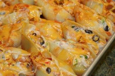 A lot of you have asked for it and here it is!!! Busy-at Home.com shared her HIGHLY sought after ....

MEXICAN STUFFED SHELLS!!!!!! 
I love them so much and I know you all do too!!
Be sure to "share" this with your friends to save it to your timeline or "tag" yourself to have it save in your photos!!

4 cups chicken breast, cooked and chopped
1 can black beans, rinsed and drained
6 green onions, diced
1/2 each of red, green, yellow, & orange bell peppers (or 2 whole bell peppers of your choice), diced
3 (8 oz.) blocks cream cheese, softened (not melted)
2 cans diced tomatoes with chiles (don’t drain) (Rotel or store brand, either works)
1/4 - 1/2 cup chicken stock
1 tsp cumin
1 1/2 cups sharp cheddar cheese, shredded
1 cup of picante sauce
38 large pasta shells, cooked al dente
For directions ---- 
http://busy-at-home.com/blog/mexican-chicken-stuffed-shells-my-secret-recipe-club-entry-for-june/