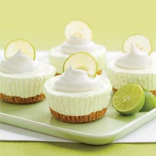 MINI KEY LIME CHEESECAKES

1 muffin pan (12 muffins)
1 box vanilla wafers
2 limes
2 8oz packages philly cream cheese(softened)
3/4 Cups granulated sugar
1 8oz tub cool whip
1 can Reddi-whip
12 muffin pan liners
(This recipe can make more than 12 so the extra you can cont. 
  until you have no more cheesecke mix.)
Prep Muffin pan by placing 1 liner in each muffin cup and then add 1 vanilla wafer. Set aside.
Squeeze the juice from 1 lime
Mix softened cream cheese, sugar and fresh lime together w/hand mixer on low, until well blended. (taste the mixture to determine if there is enough lime flavor to your liking, you may need to add 1 tsp more of fresh lime juice.)
Gently with a cake spatula fold in the 8oz tub of cool whip until all mixed in.
Fill the lined muffin pans to the top.

Refrigerate at least 1 hour.
Remove from fridge and remove cheesecakes from pan you can repeat if you have leftover mix. 
Remove liners from the cakes and place on serving dish add dollop of reddi-whip and thin slice of lime. I usually cut lime in half it looks better. Then serve!
If you aren't ready to serve you can still remove cheesecake from pan leaving liners on and wait til serving to remove liners and decorate!