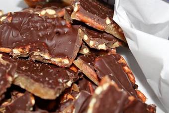 OMG.......Salted Caramel Pretzel Bark
this is sooo easy to make!

2 sticks of butter
1 cup of light brown sugar
1 reg. bag of pretzels (you'll use about 3/4 of the bag)
12 ounce bag of chocolate chips
Sea salt - ( I use our coarse sea salt with our grinder)

Preheat the oven to 400.

Line a large bar pan with parchment paper, cover with pretzels 
In a medium saucepan melt the butter over medium-low heat. When it begins to bubble add the brown sugar. Stirring occasionally let the butter/sugar mixture meld together and brown. This should take about 3 minutes. Do NOT let it boil, you will have sticky goo that is no good. When you have a nice, brown caramel pour it over the pretzels, slowly and evenly. You can then use a spatula to spread it out, you have to work quickly and gently. It hardens fast so even pouring is the best method.

Bake the sheet for 5 minutes.

Remove the sheet from the oven and sprinkle the whole bag of chocolate chips evenly over the mixture. 

Place back in the oven for about 45 seconds. If you let it sit there too long the chocolate will burn. 

Remove from the oven and use a silicone spatula to evenly spread the chocolate over the top. 

Sprinkle with sea salt and refrigerate for a minimum of 1 hour. 

http://avocadopardo.blogspot.com/2011/11/salted-caramel-pretzel-barkaka-heaven.html