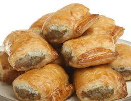 Sausage Rolls (British Recipe) - Meaty sausages wrapped in puff pastry -  Sausage Rolls are a perfect food for a picnic, buffet, party, lunch box or simply a snack. Sausage rolls are so quick and easy to make and as they freeze really well, make a large batch.

I have made these here in the US and people just can't get enough of them. You will have to trust me on this but I know you will not be disappointed.

Prep Time: 15 minutes

Cook Time: 25 minutes

Total Time: 40 minutes

Yield: Makes according to size.

Ingredients:

1 onion, finely chopped
1 tbsp vegetable oil
24 oz/750g sausage meat
3 medium sized eggs
24 oz /750g puff pastry
Preparation:

Preheat the oven to 400°F/200°C/Gas 6
Gently cook the onion in the vegetable oil for 7 minutes. .
Place the sausage meat into a large mixing bowl, add the onion mixture and two eggs. Mix well until all the ingredients are thoroughly and evenly mixed.
On a lightly floured surface, roll out half the pastry to a 8" x 10" (20cm x 25cm) rectangle. Cut lengthwise into 2 strips. Repeat with the remaining pastry. Rest the pastry for at least 10 mins in the refrigerator.
Form the sausage meat into 4 long sausages the length of the pastry strips. Place each sausage into the center of each pastry strip. Beat the 3rd egg in a basin and lightly brush the edges of the pastry with the beaten egg.
Fold the pastry over the meat filling to form two long rolls then flip the sausage roll over so the seam is underneath. Brush the top surface lightly with beaten egg.
Cut the rolls into 1/1/2"/4cm lengths - you can vary the length to the style of roll you want, for a canape size you may want to make tiny rolls. Place the sausage rolls on a greased baking sheet and cook in the preheated oven for 20 minutes or until golden brown.
Pack into your picnic basket, lunch box, or simply eat and enjoy when cool.